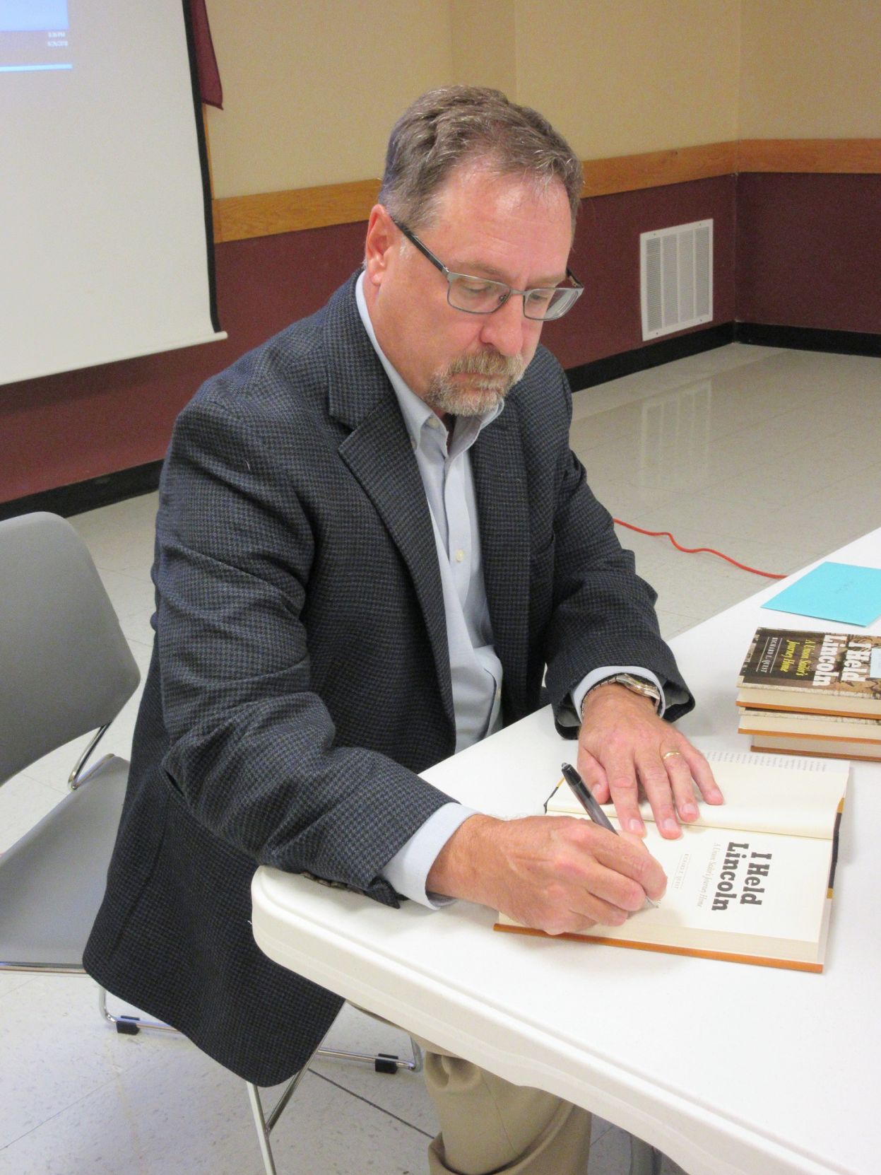 After relating the adventures of Lt. Benjamin Loring, Richard Quest signed books and chatted with friends and former students.